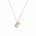 Detailed close-up of 18K gold letter E pendant with sparkling cubic zirconia inlay - Letter E