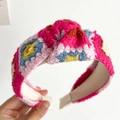 Detail of hand-crocheted floral headband showing colorful knit textures and knotted design - Red Flowers Knotted Knitted Headband