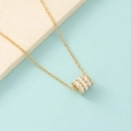 Close-up of gold-plated cylinder pendant necklace featuring three rows of sparkling zircons - Gold (MP405)