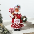 Detail of female chef Christmas doll with red plaid apron holding a festive lollipop - Female Chef with Lollipop