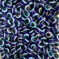 Detailed view of bulk blue evil eye resin beads for DIY jewelry making and necklaces - Sapphire Blue / 10mm