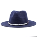 Close-up of navy blue straw sun hat featuring decorative white natural stone beads - Navy Blue