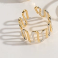 Two-tone wavy open ring in gold and silver finish with dramatic shadows on white background - Wave Fence Style