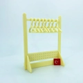 Detail of yellow acrylic earring organizer with 8 mini hangers and perforated display base - Yellow