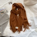 Caramel soft cashmere-feel scarf with tassels and MC&MO label laid on white bedding - 200*65cm / Caramel color