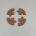 Close-up of 4-piece walnut wood jigsaw coasters with precise laser-cut edges and dimensions - Round 4-Piece Set