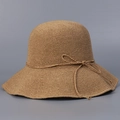 Detail of hand-woven khaki straw hat showing crochet texture and bow decoration - Khaki