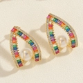 Macro view of gold arch earrings with rainbow zircons and a central white pearl - Rainbow Pearl (ES2152-5)