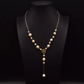 Elegant gold-tone Y-shape necklace featuring white freshwater pearls and a circular cutout charm - Hollow Round Buckle Pearl Necklace