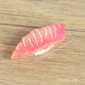Realistic PVC salmon nigiri sushi model with orange texture and white rice base 7cm - Sea Fish Sushi (Small) / Pink
