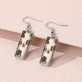 Rectangle cow print drop earrings with silver metal frames on pink textured background - Brown Cow Texture (FXEH-27-10)