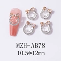 Makroaufnahme von Smile-Nailart-Anhängern mit Schleife und Strassstein-Inlay - Champagner Schleife Silberner Smiley Stil (AB78)