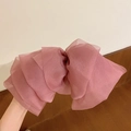 Detail of pink organza bow hair clip featuring layered translucent fabric and spring clip - Light Pink Chiffon Large Bow Hair Ornament / Light Pink