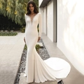 Elegant white satin mermaid wedding dress with deep V-neckline and beaded long sleeves - US 6 / Ivory