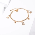 Detail of a golden bear bracelet with rhinestone charms and 750 hallmark engraving - Hollow Bear Zirconia Gold