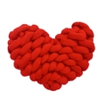 Detail of a handmade red heart-shaped knotted pillow with soft knitted texture - Red