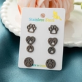 Set of four pairs of black stainless steel cat paw print stud earrings on display card - Black