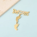 Detailed view of gold MOM letter pendant with crystal heart and baby feet charms - Gold Tone MOM + 2 Feet Pendant
