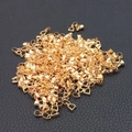 Close-up of golden metal pinch bails for DIY jewelry making on black leather - Gold Pinch Bails 14mm (10pcs)