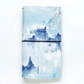 Artistic traveler's notebook featuring blue ink landscape cover and black elastic strap - Distant Mountain