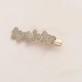 Dettaglio del fermaglio per capelli dorato con tre orsetti e brillanti strass bianchi - Stile Tre Farfalle Strass