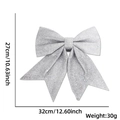 Detail view of a large silver glitter bow ornament, sized 27cm by 32cm for Christmas decor - G:No.3 (32x27cm) / Silver
