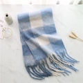 Close-up of soft blue and white checkered scarf with fringe on a marble background - Blue White Rainbow Plaid