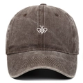 Close-up of white bee embroidery on vintage washed cotton baseball cap in dark brown - Coffee