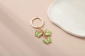 Golden butterfly keychain with three green acrylic charms and sparkling rhinestones - Green