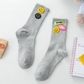 Light gray mid-calf knit socks featuring colorful smiley face and letter patches - One Size / Gray