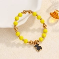 Elastic beaded bracelet with yellow stones and gold metal beads featuring a black bear charm - Yellow Beads-Black Bear Charm
