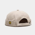 Detail of khaki cotton miki hat featuring yellow smiley face embroidery and metal strap - Solid Smile Beige