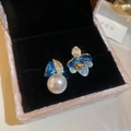 Macro shot of asymmetric vintage earrings with blue enamel flowers and pearls - Blue Asymmetric 3D Floral Silver Needle Style (46#)