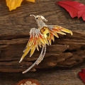 Vintage phoenix enamel brooch with yellow crystals on wood with autumn leaves - Gold Rhinestone Phoenix