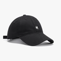 Minimalist black baseball cap with white embroidered letter H logo and curved brim - Black