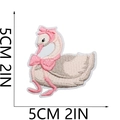 Detailed close-up of a pink swan embroidery patch with a bow measuring 5cm by 5cm - Pink Swan