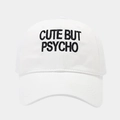 Detail of black 'CUTE BUT PSYCHO' embroidery on a white cotton baseball cap - White