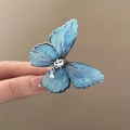 Detail of blue butterfly hair clip with shimmering rhinestones and a white pearl drop - Hair Bow / Light Blue