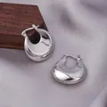 Elegant thick teardrop hoop earrings in polished silver finish on luxury silk fabric - E-024---Platinum