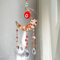 Golden moon crystal suncatcher with evil eye beads and orange healing stones - Red/Orange