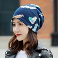 Women's slouchy beanie in navy blue featuring a colorful feather print pattern - Standard / Dreamy Feather Navy Blue