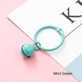 Mint green metal bell keychain with a matching snap ring on a pastel background - Mint Green