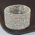 Macro shot of silver-colored multi-row rhinestone bridal stretch bracelet on wood - 9 Row Silver Clear Rhinestone Bracelet