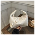 Detail of silk texture handbag featuring traditional floral embroidery and pearl zipper pull - White