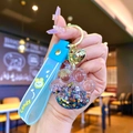 Blue cat paw liquid sand keychain with glitters and star charms on a sky blue strap - Black Luminous Bubble Bead Cat Paw