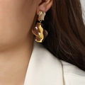 Elegant geometric gold earrings with brown and beige enamel on a fashion model - Brown Enamel Style (F1163)