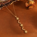 Vintage gold celestial necklace featuring sun and moon pendants with crystals on O-chain - Gold Sun Moon Tassel Necklace