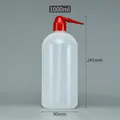 Macro detail of a 1000ml plastic squeeze bottle showing clear measurement scales - 1000ml (Red Tip)