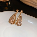 Macro shot of vintage gold teardrop earrings with champagne crystals on ceramic - Alloy/Rhinestone/S925 Silver Pin / Hollow Teardrop Style / Champagne Gold Rhinestone Teardrop Earrings (HE18169)