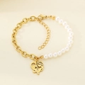 Detail of gold titanium bracelet featuring mother-child heart pendant and pearls - Heart Mother And Child Embrace (KB203698-Z)